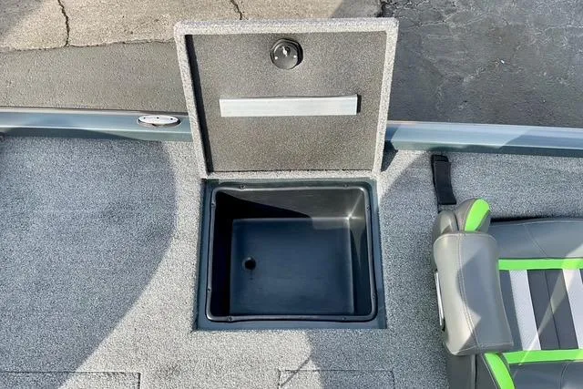 Slide: The Image of 2023 Ranger RT198P boat storage compartment with open lid and adjacent seating. - 5