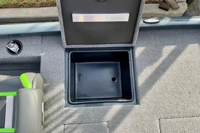 Slide: The Image of 2023 Ranger RT198P boat storage compartment with open lid, gray interior, and green-accented seat. - 6