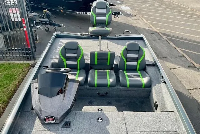 Slide: The Image of 2023 Ranger RT198P boat interior with green-accented seats and steering console. - 7
