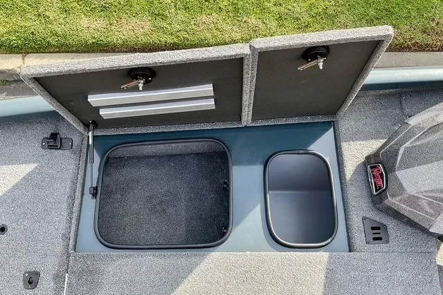 Slide: The Image of 2023 Ranger RT198P boat storage compartments with open lids, showcasing interior space. - 9