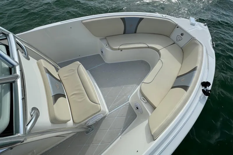 Slide: The Image of 2015 Century 2600 CC boat with beige seating, on calm water. - 11
