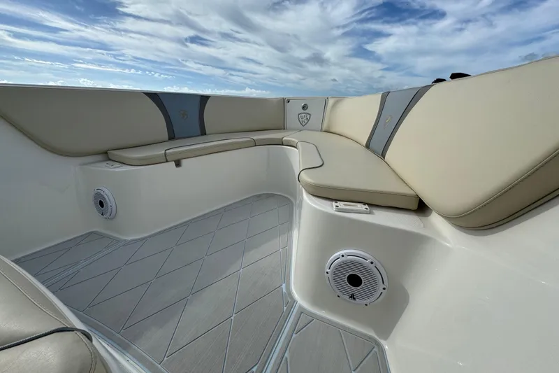 Slide: The Image of 2015 Century 2600 CC boat interior with beige seating and marine speakers. - 19