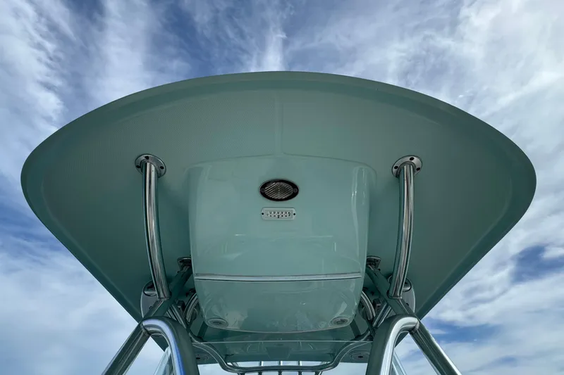 Slide: The Image of Century 2600 CC 2015 boat T-top against a cloudy sky background. - 24