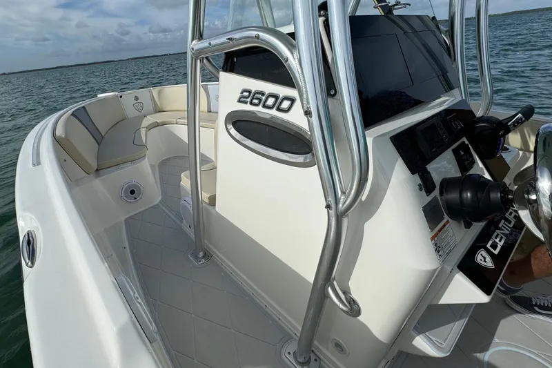Slide: The Image of 2015 Century 2600 CC boat interior with helm and seating, on open water. - 26