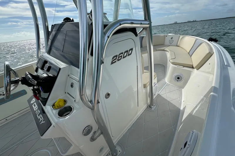 Slide: The Image of 2015 Century 2600 CC boat interior with seating and control panel on the water. - 27