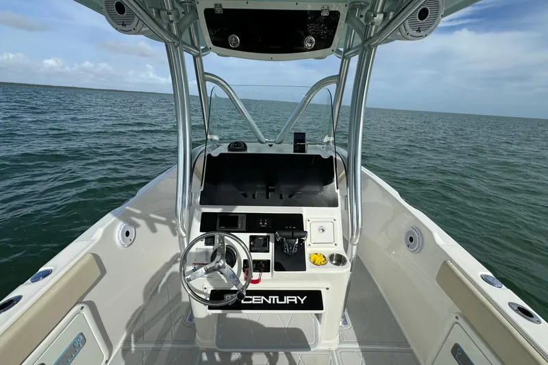 Slide: The Image of Century 2600 CC 2015 boat dashboard with steering wheel, on open water. - 31