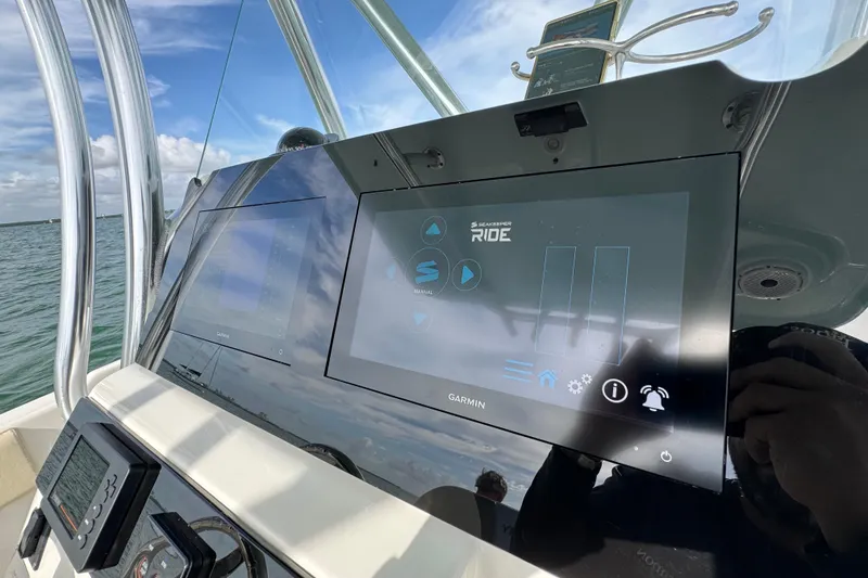 Slide: The Image of Century 2600 CC 2015 boat dashboard with Garmin navigation system on open water. - 33