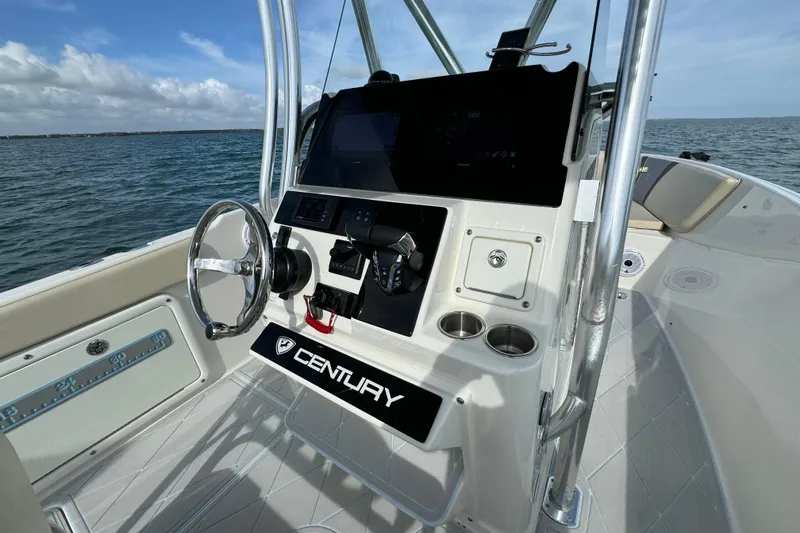 Slide: The Image of 2015 Century 2600 CC boat console with steering wheel and controls on open water. - 39