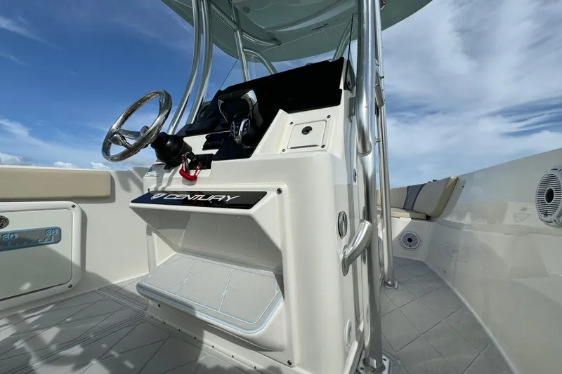 Slide: The Image of 2015 Century 2600 CC boat console with steering wheel and controls under blue sky. - 46