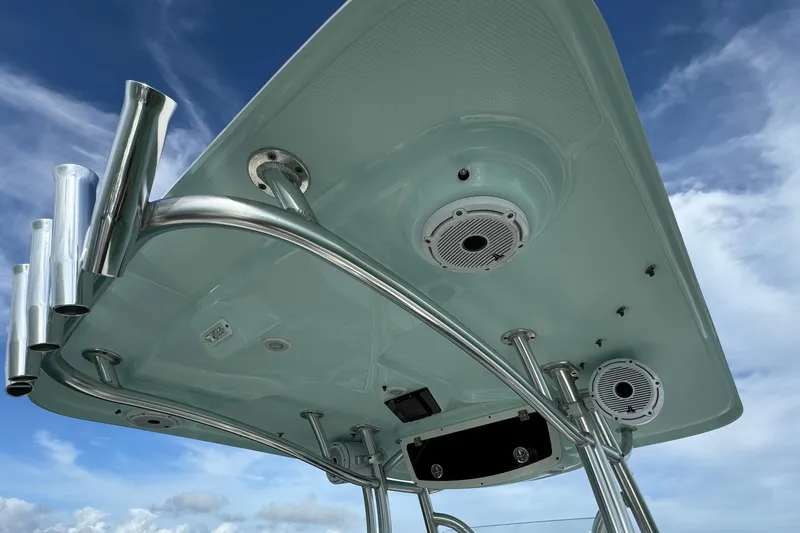 Slide: The Image of Century 2600 CC 2015 boat's T-top with speakers and rod holders against blue sky. - 50