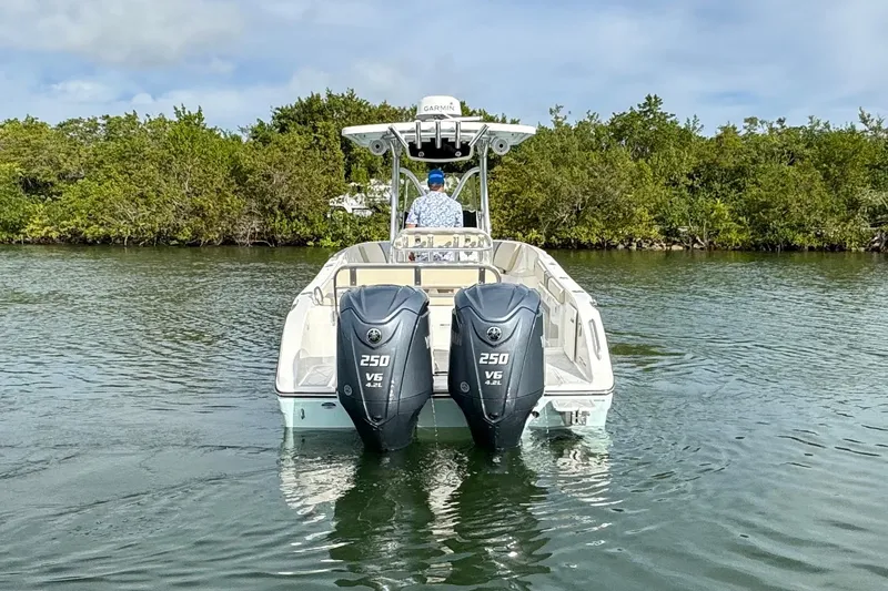 Slide: The Image of 2015 Century 2600 CC boat with dual 250 V6 engines on a calm waterway. - 6