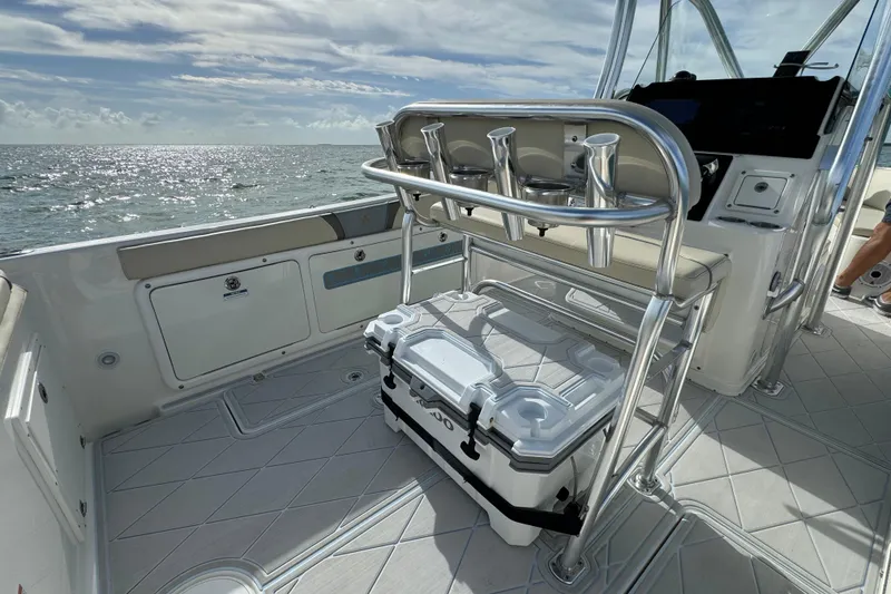 Slide: The Image of Century 2600 CC 2015 boat interior with seating and cooler on a sunny day. - 61