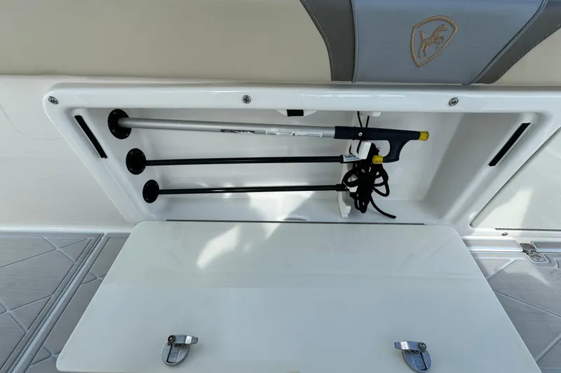 Slide: The Image of Storage compartment on a 2015 Century 2600 CC boat, featuring organized equipment. - 70