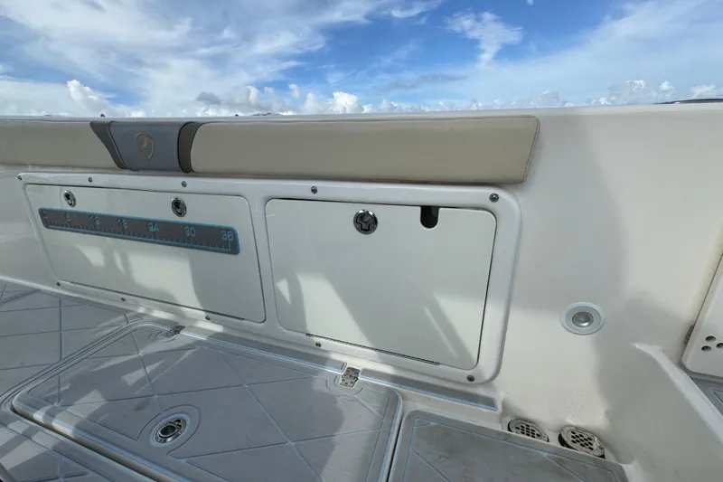 Slide: The Image of 2015 Century 2600 CC boat interior with storage compartments and ruler, under a blue sky. - 71