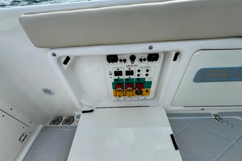 Slide: The Image of Control panel on a 2015 Century 2600 CC boat, featuring various switches and outlets. - 74