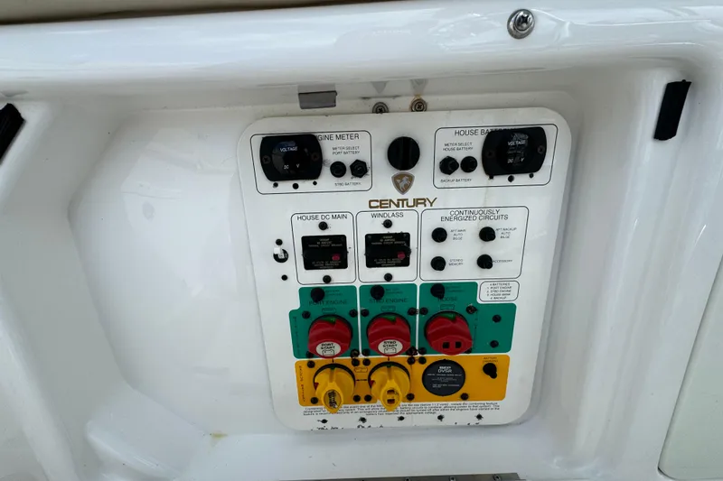 Slide: The Image of Control panel of a 2015 Century 2600 CC boat, featuring various switches and meters. - 75