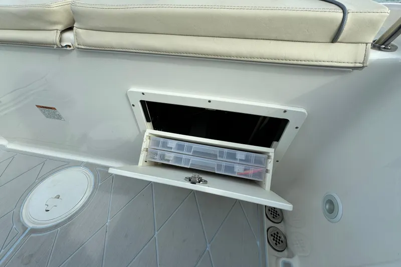 Slide: The Image of 2015 Century 2600 CC boat storage compartment with tackle box. - 76