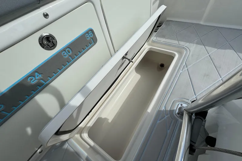 Slide: The Image of Open storage compartment on 2015 Century 2600 CC boat with measurement scale. - 83