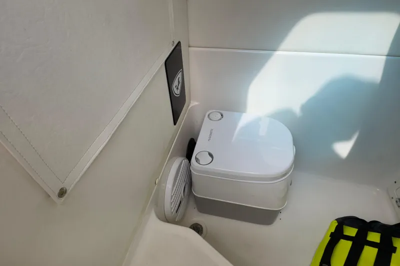 Slide: The Image of Portable toilet in 2015 Century 2600 CC boat cabin with life jacket nearby. - 86