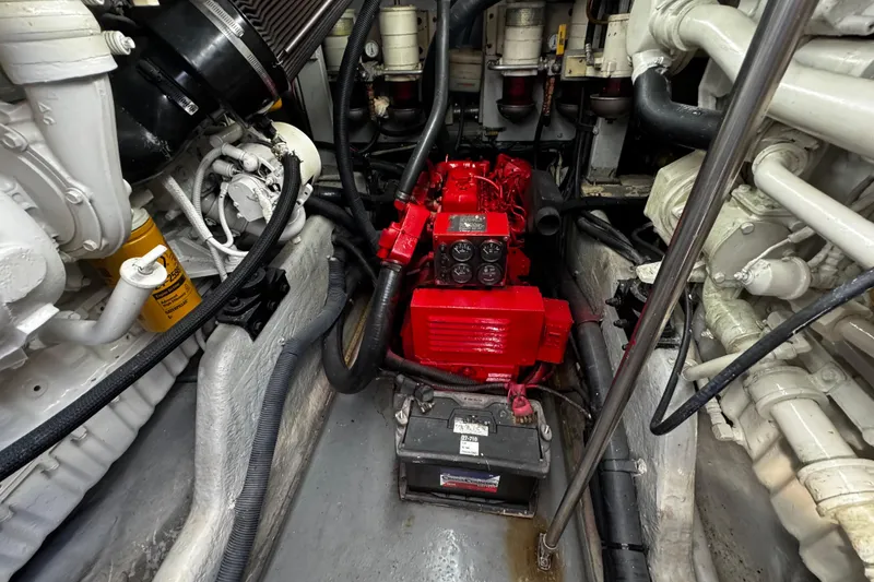 Slide: The Image of Engine room of a 1999 Sea Ray 440 Express Bridge with visible components and battery. - 42