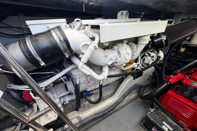 Slide: The Image of Engine compartment of a 1999 Sea Ray 440 Express Bridge boat, showcasing mechanical components. - 43