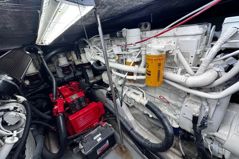 Slide: The Image of Engine room of a 1999 Sea Ray 440 Express Bridge with visible components and wiring. - 44