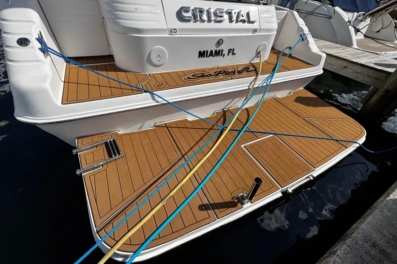 Slide: The Image of 1999 Sea Ray 440 Express Bridge docked in Miami, FL with teak deck and blue ropes. - 5