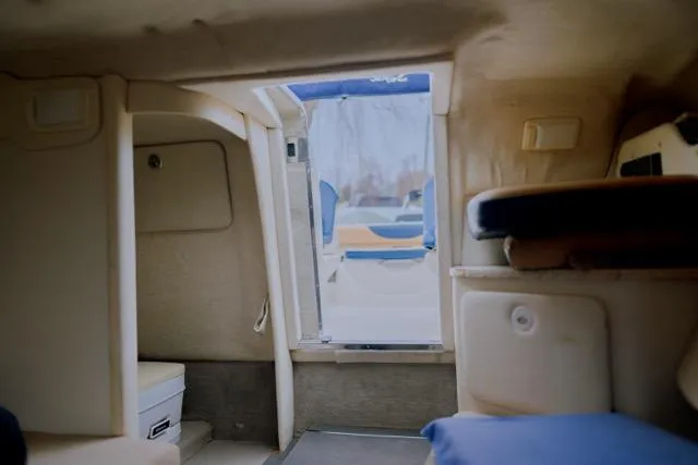 Slide: The Image of Interior view of 2007 Sea Ray 215 Weekender boat cabin with open door. - 8