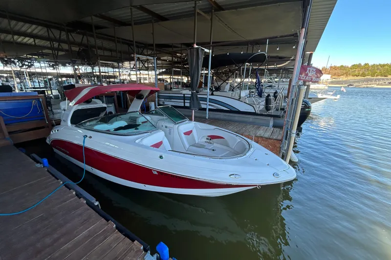 The Image of 2008 Chaparral 276 SSX boat docked in marina, featuring red and white design. - 0