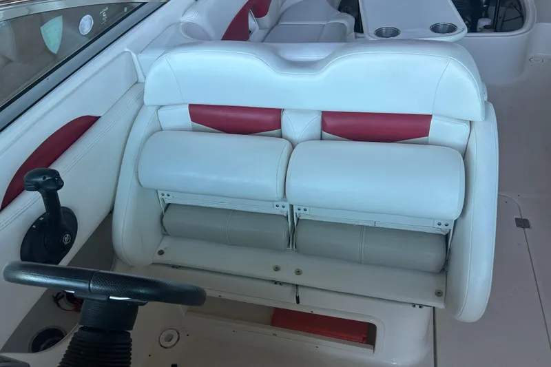 Slide: The Image of 2008 Chaparral 276 SSX boat interior with white and red seating, steering wheel, and cup holders. - 12