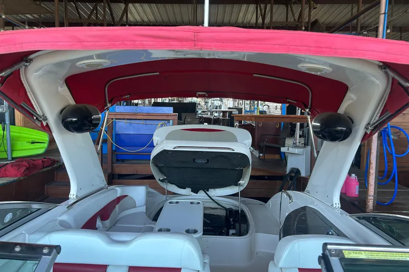 Slide: The Image of 2008 Chaparral 276 SSX boat interior with red canopy and seating. - 16