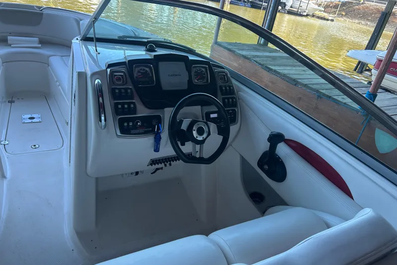 Slide: The Image of 2008 Chaparral 276 SSX boat cockpit with steering wheel and control panel. - 9