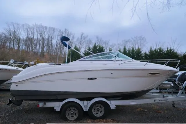 Slide: The Image of 2007 Sea Ray 215 Weekender boat on trailer, parked outdoors. - 0
