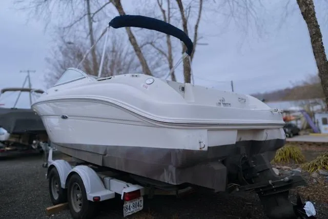Slide: The Image of 2007 Sea Ray 215 Weekender boat on trailer, parked outdoors. - 1