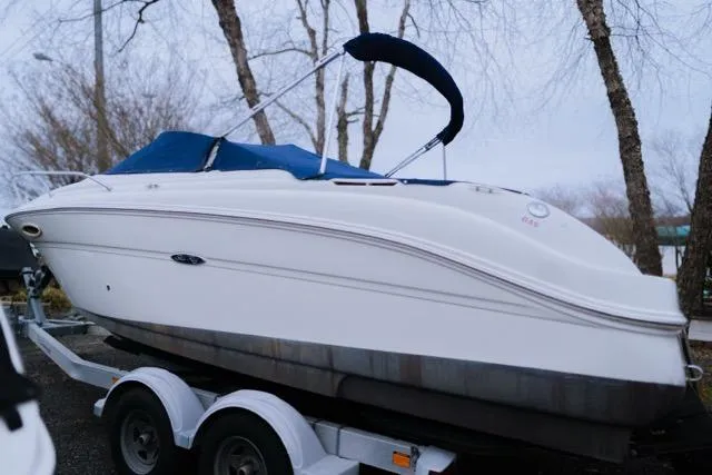 Slide: The Image of 2007 Sea Ray 215 Weekender boat on trailer, blue canopy, parked outdoors. - 3