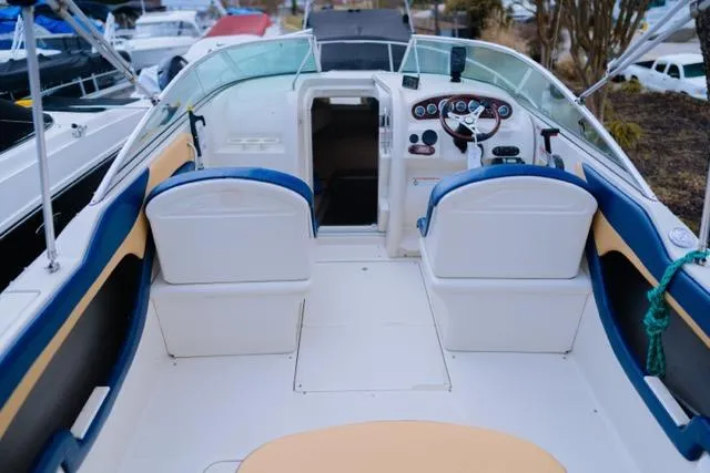 Slide: The Image of 2007 Sea Ray 215 Weekender boat interior with helm, seating, and open cabin entrance. - 10