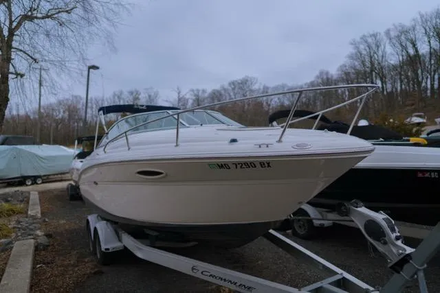 Slide: The Image of 2007 Sea Ray 215 Weekender boat on trailer, parked outdoors in wooded area. - 5