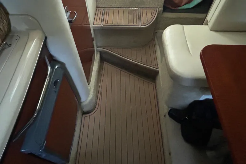 Slide: The Image of Interior of a 2005 Sea Ray 280 Sundancer boat with wood flooring and seating. - 18