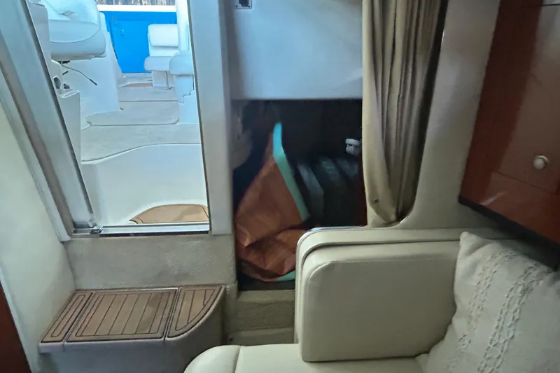 Slide: The Image of Interior of 2005 Sea Ray 280 Sundancer boat, featuring seating and cabin area. - 19