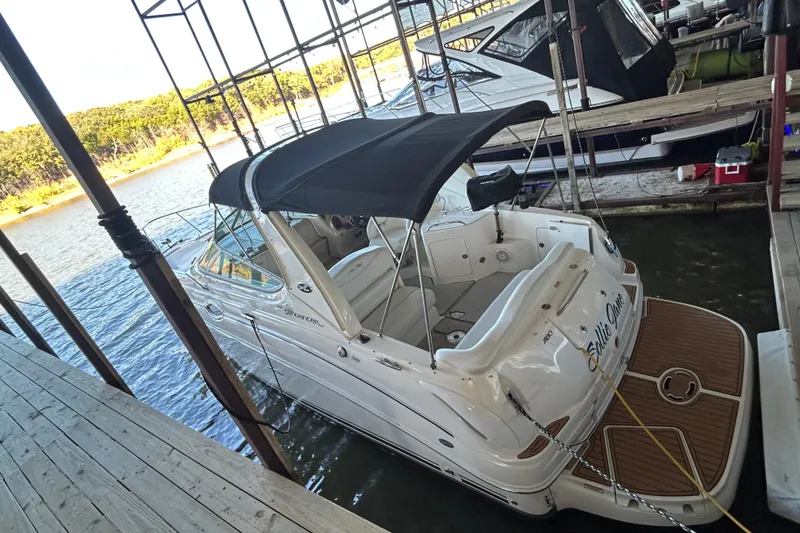 Slide: The Image of 2005 Sea Ray 280 Sundancer docked, featuring a sleek design and spacious deck. - 3