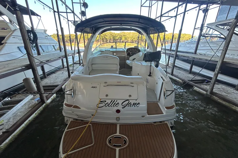 Slide: The Image of 2005 Sea Ray 280 Sundancer docked, rear view with teak deck and canopy. - 4