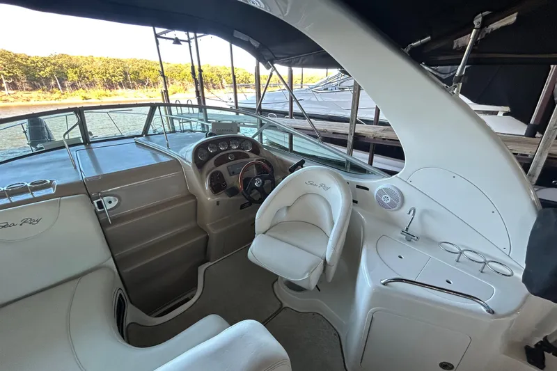 Slide: The Image of 2005 Sea Ray 280 Sundancer cockpit with steering wheel, seating, and control panel. - 8