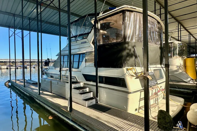 Slide: The Image of 1989 Carver 38 Aft Cabin Motor Yacht docked in a marina. - 12