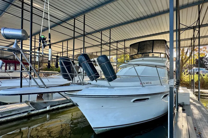 Slide: The Image of 1989 Carver 38 Aft Cabin Motor Yacht docked in a covered marina. - 13