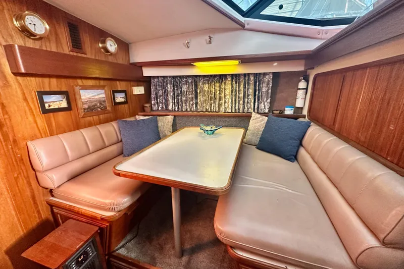 Slide: The Image of Cozy dining area in 1989 Carver 38 Aft Cabin Motor Yacht with plush seating and decor. - 17