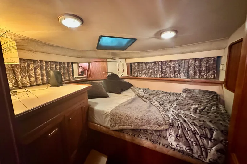 Slide: The Image of Cozy cabin interior of 1989 Carver 38 Aft Cabin Motor Yacht with bed and decor. - 18