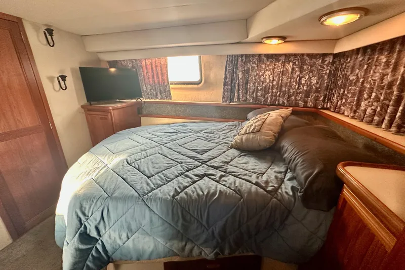 Slide: The Image of Cozy bedroom in 1989 Carver 38 Aft Cabin Motor Yacht with TV and window. - 24