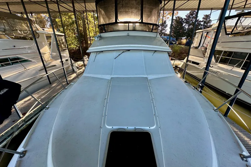 Slide: The Image of 1989 Carver 38 Aft Cabin Motor Yacht docked in a marina. - 4