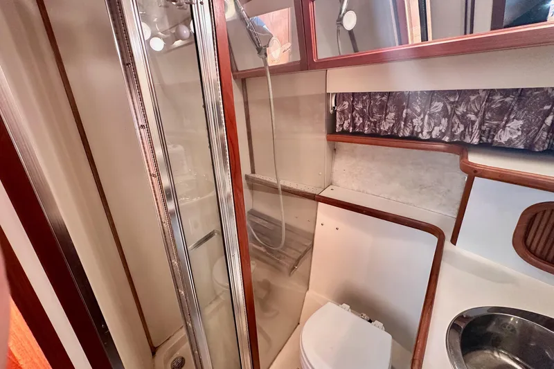 Slide: The Image of 1989 Carver 38 Aft Cabin Motor Yacht bathroom with shower, sink, and toilet. - 19