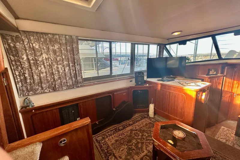 Slide: The Image of Interior of 1989 Carver 38 Aft Cabin Motor Yacht with cozy furnishings and natural light. - 21